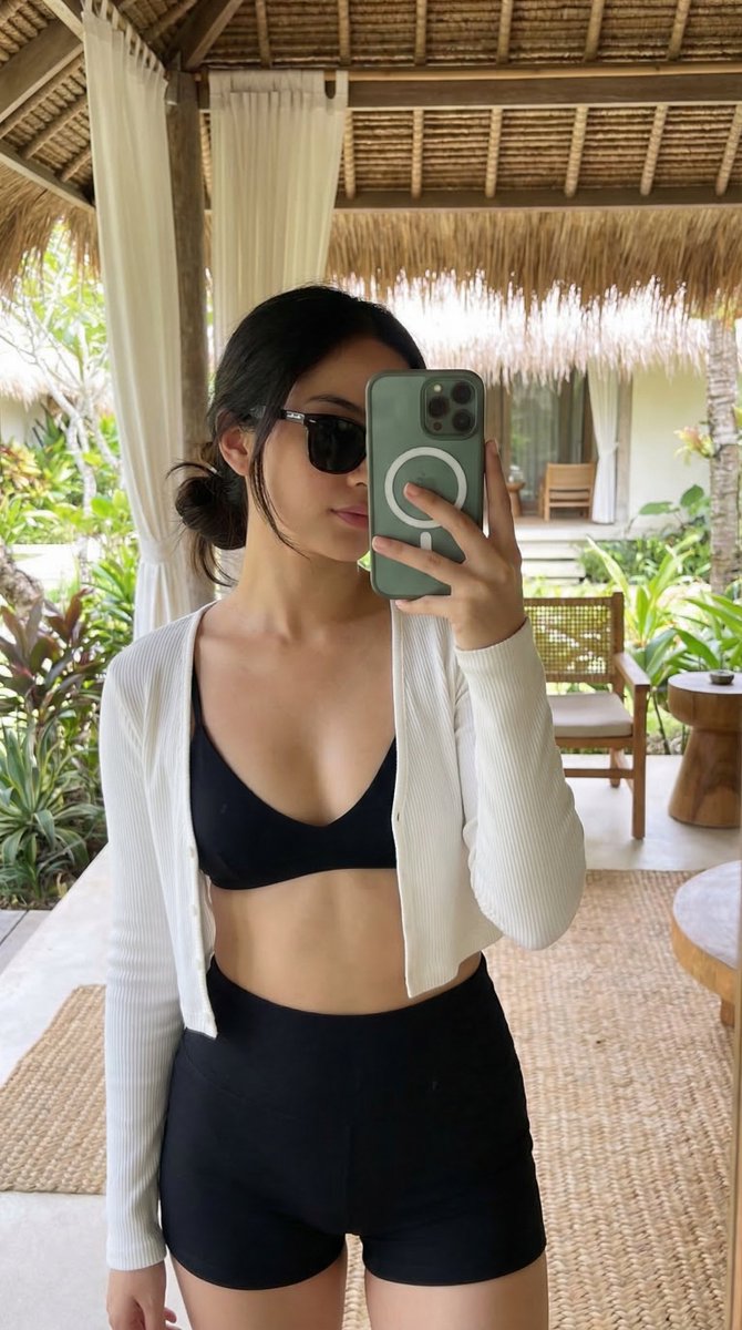{ "subject": { "description": "A slim young woman taking a tropical resort mirror selfie, with a...