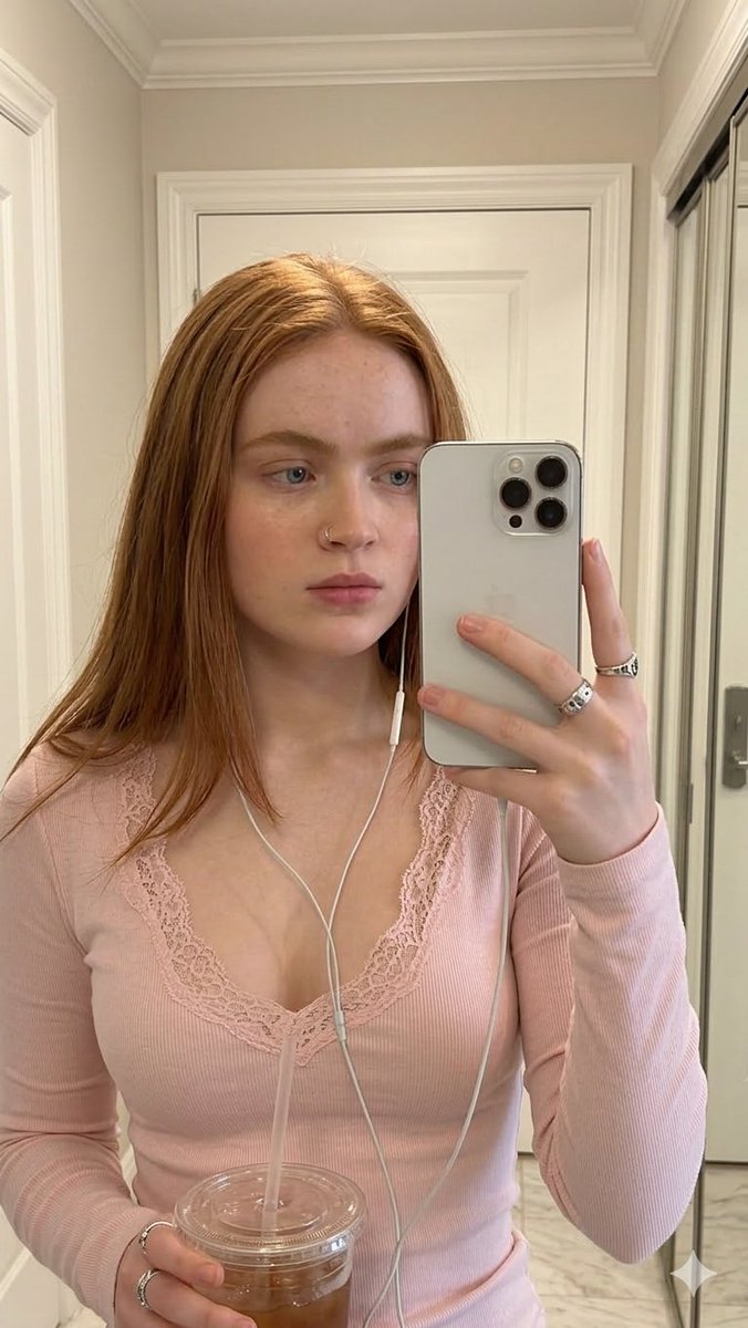 女性, early_20s, soft, composed, slightly serious, holding smartphone up for mirror selfie with on...