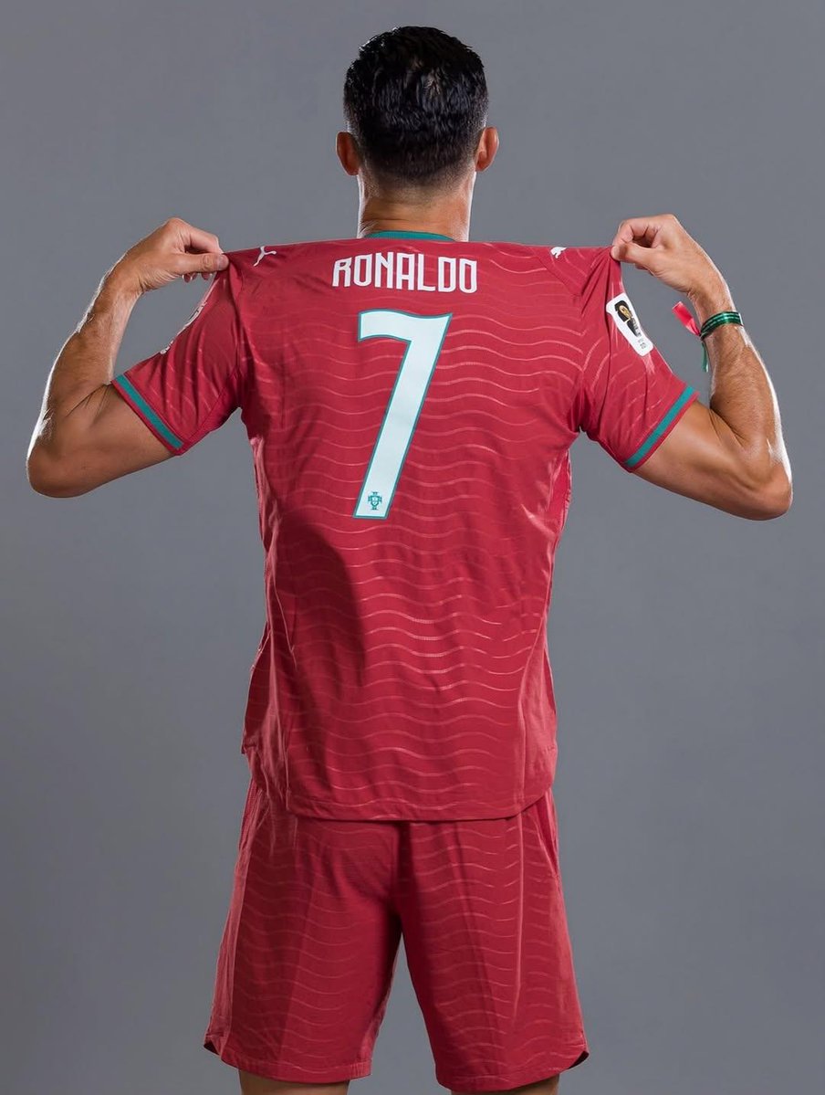 超写实克里斯蒂亚诺·罗纳尔多（Cristiano Ronaldo）肖像，身穿葡萄牙国家队球衣，7 号球衣，英雄般矗立在一座巨型足球场的中央，表情坚毅，冠军气场，头上方漂浮着一顶金色皇冠，身体周...