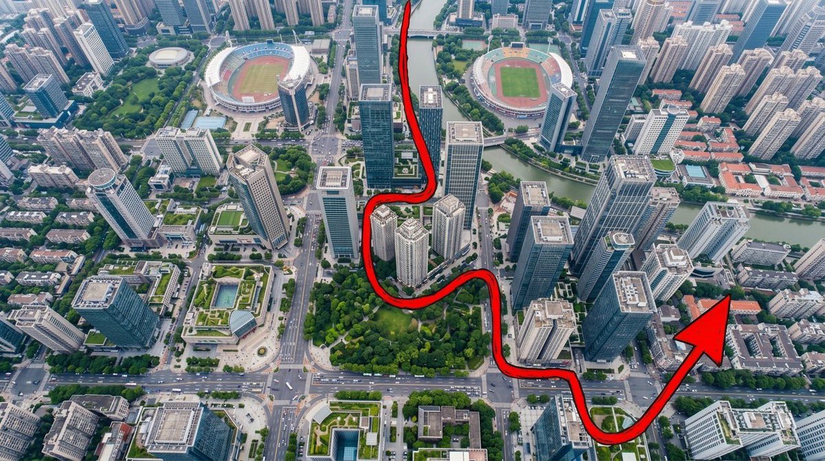 “一张从正上方拍摄的、写实风格的航拍无人机照片，呈现一座密集、充满活力的现代城市：摩天大楼鳞次栉比，城市街区排列有序，街道上布满小巧的车辆，建筑...
